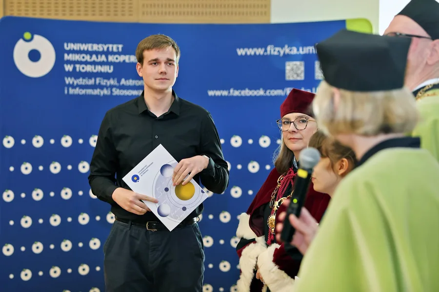 Dariusz Kierski listens as the Dean highlights his achievements