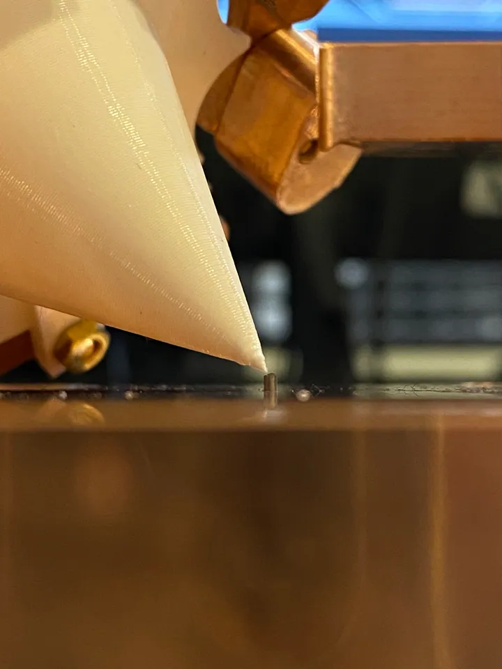 Close-up of a conical alignment guide and a positioning pin