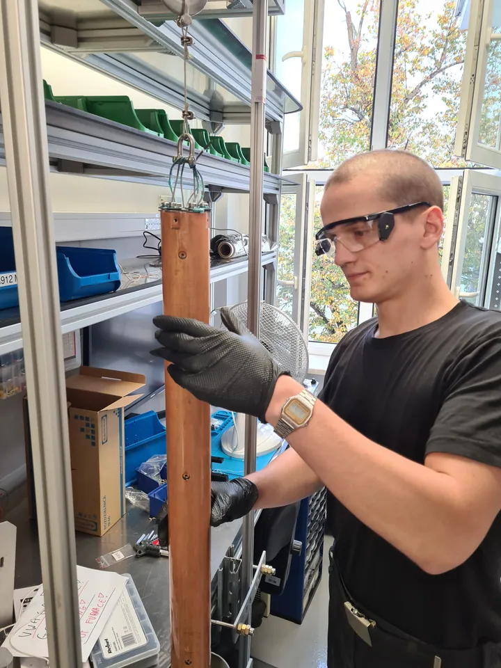 Handling the long copper chamber during assembly